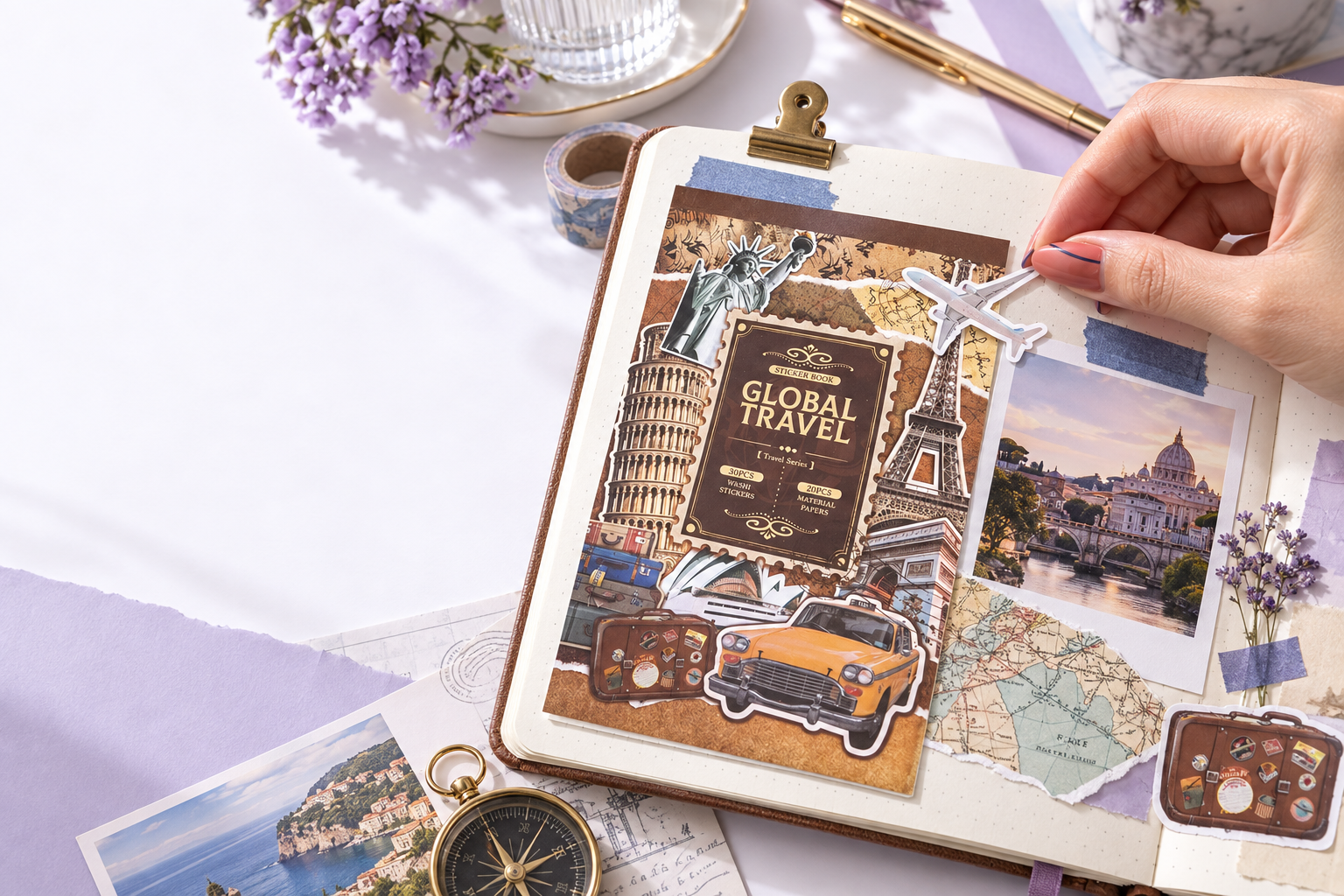 A manicured hand adding a travel sticker beside photos and a map in a journal